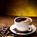 15195673-coffee-cup-and-saucer-on-a-wooden-table-dark-background